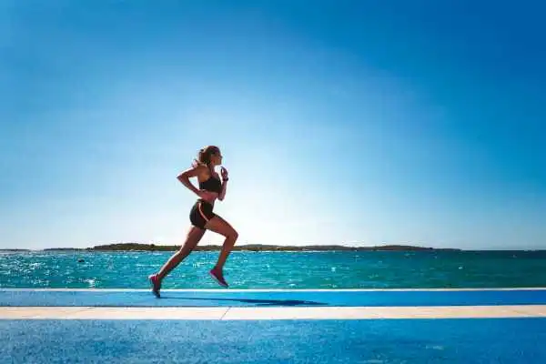 Woman running showing strong leg muscle Streatley